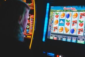 A man playing a slot machine game, gambling away.